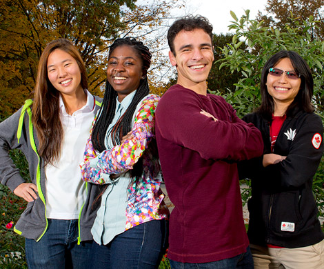 A group of four international students – three female and one male –enjoying at day outdoors on the Rose-Hulman campus.