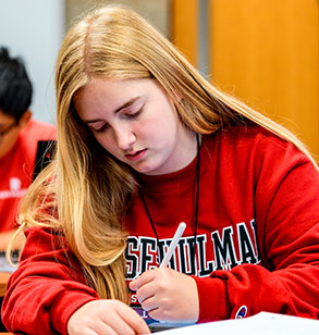 Student works in a classroom.