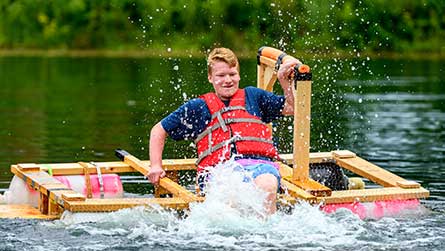 Student on raft project in lake