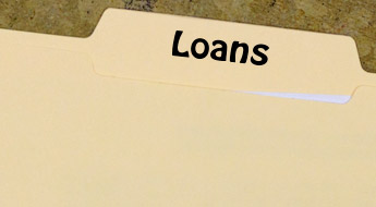 !Image shows a manila folder containing a sheet of paper. The folder is labeled Loans.
