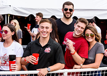 !Group of young alumni at Homecoming event