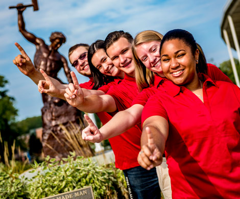 Five students standing in front of Self-Made Man statue, each holding up one finger to represent Rose-Hulman’s #1 ranking.
