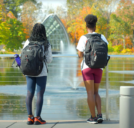 Two students looking into Speed Lake.