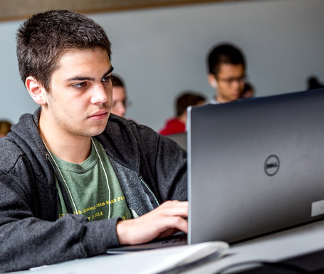 !Student using a laptop computer.