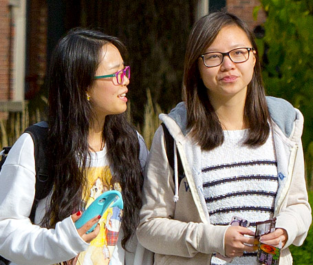Two female international students walking on campus