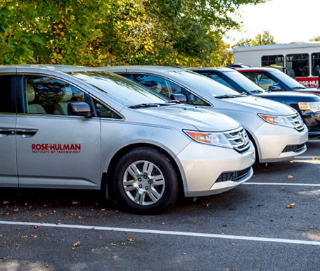 !Rose-Hulman vehicles parked in a parking lot.