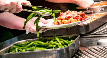 !A plate of green beans and lasagna being served up inside the Union Café.