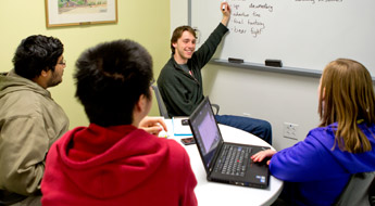 Students listening to a tutor inside the Learning Center.