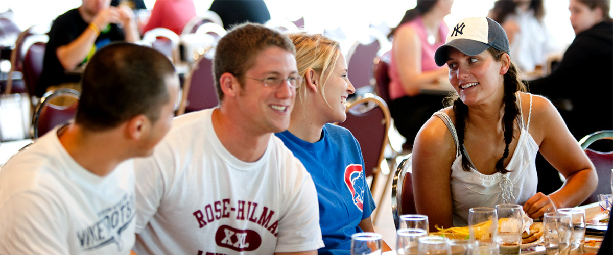 Smiling students enjoy conversation over lunch in the dining room of the Hulman Memorial Student Union.