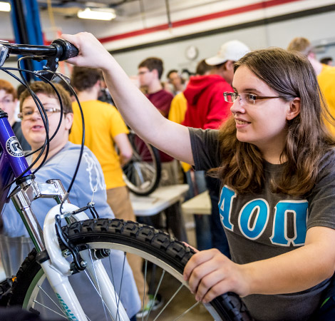 Students building bicycles at the annual Bikes for Tykes event