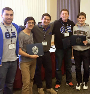 Members of Theta Chi pose holding awards