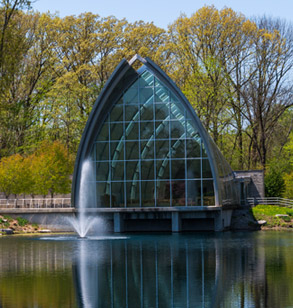 White Chapel reflecting in  Speed Lake with a fountain operating just in  front of the chapel ’ s windows. 