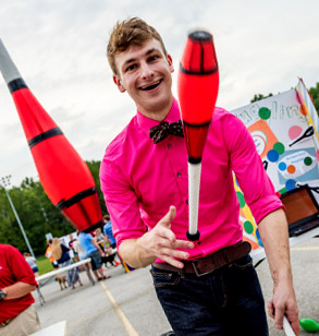 A male student member of the  Rose-Hulman juggling club performs at Cook  Stadium. 