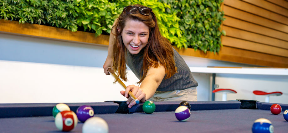 Female student playing Pool at Mussallem Union