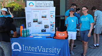Students standing at InterVarsity information table