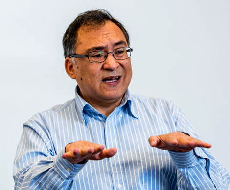 Dr. Gustavo Garcia gestures while lecturing.