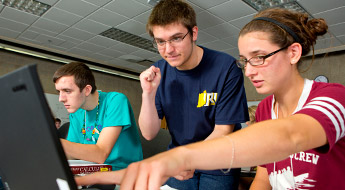 Students looking at computer screen.