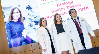 !Three biology students at their thesis presentations.