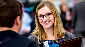 Female student talks to male recruiter
