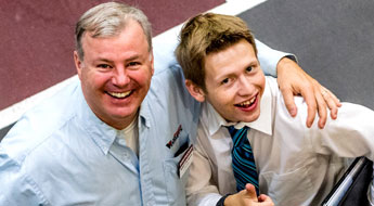 !Parent with arm around son attending career fair