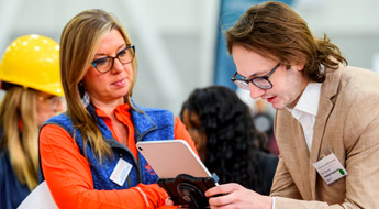 Female student talks to male recruiter