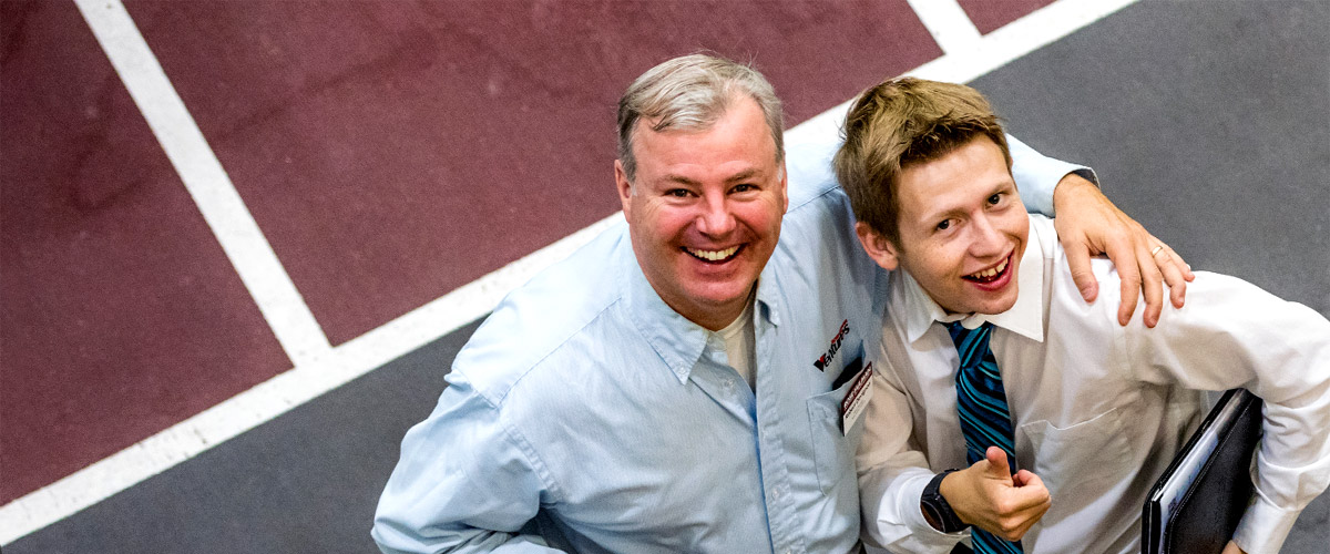 A mentor from Rose-Hulman Ventures poses with a student at the career fair.