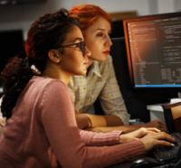 Two women coding together
