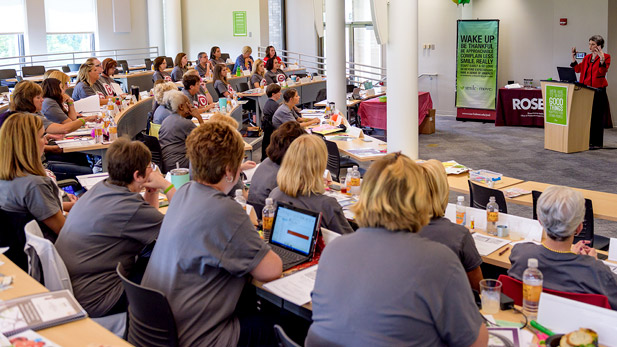 Employees seated watching a instructor during training