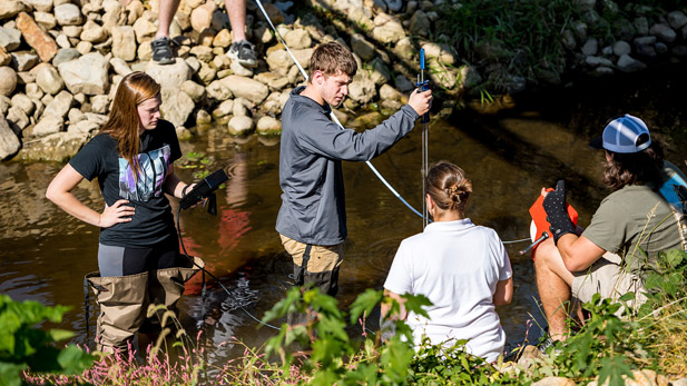 Civil engineering students collecting information in a waterway