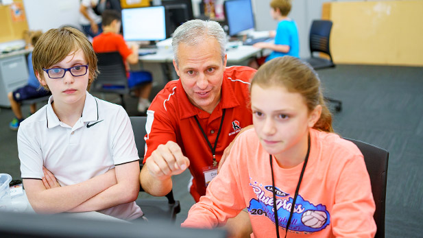 David Fisher working with students during Hour of Code