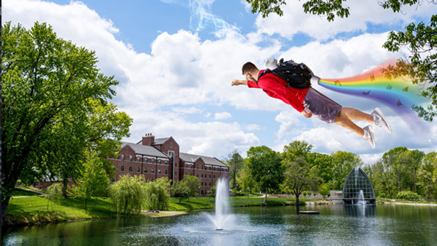 Student wearing backpack flies across Speed Lake, leaving a vapor trail of rainbows and butterflies in his wake.