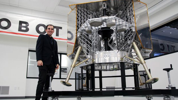 Ander Solorzano standing by a lunar lander.