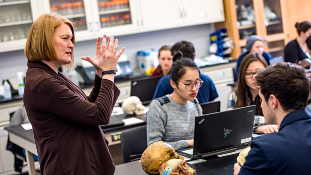 Jennifer O'Connor teaching in a classroom with students looking at their computers.