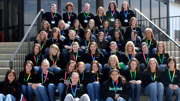 Image shows a group of more than 30 EMERGE field trip participants sitting on stairs. Teachers are at the top of the stairs.