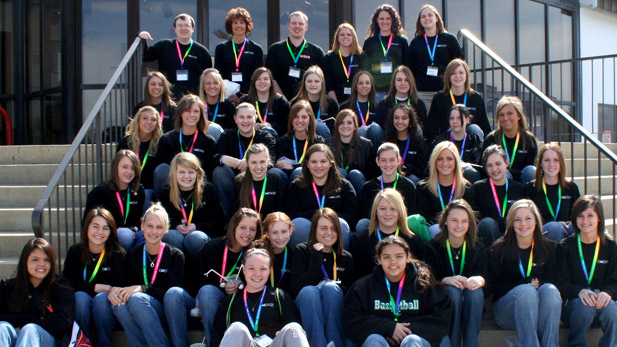 Image shows a group of more than 30 EMERGE field trip participants sitting on stairs. Teachers are at the top of the stairs. 