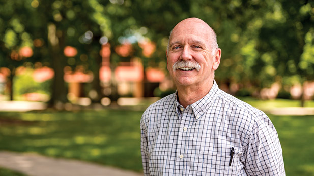 Dan Moore standing outside Moench Hall. 