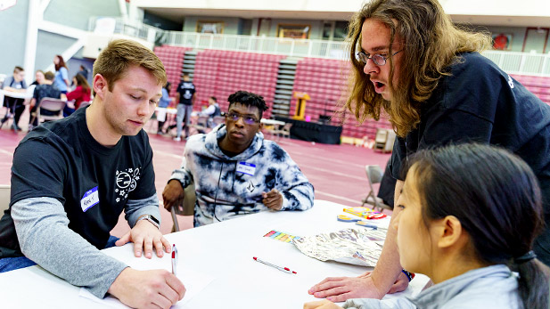 Rose student helping high school SPARK participants.