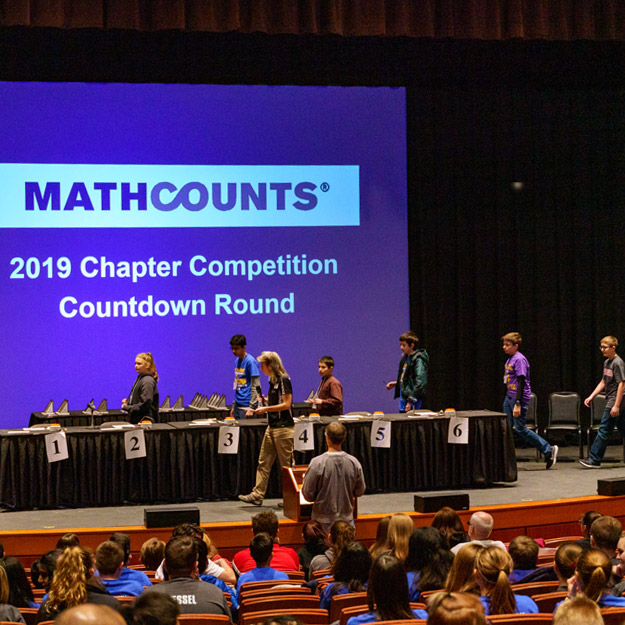 Image shows young girl working a Rubic's Cube.