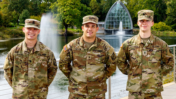 Evan Baker, Landen Berlin, and Samuel Dickinson in Army fatigues by Speed Lake.