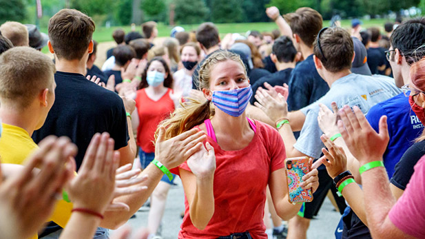 Students run through a crowd of students getting high-fives as part of Rose-Hulman's new student orientation.