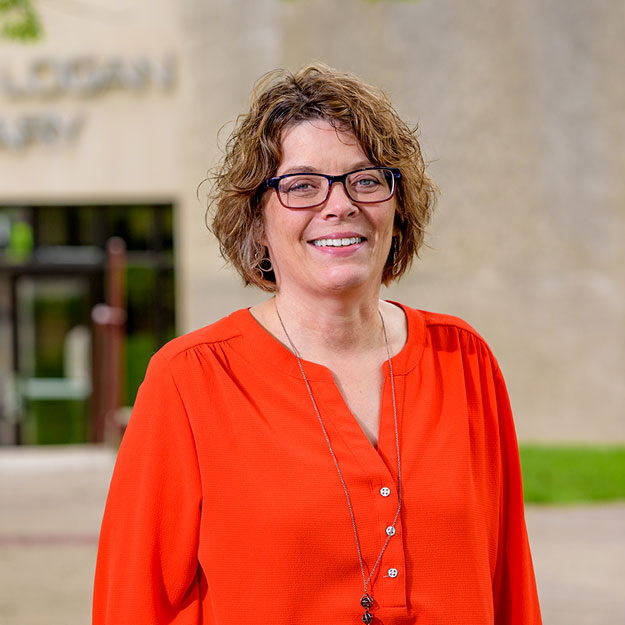 Image of Caroline Carvill standing outside Logan Library.