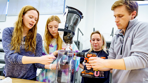 Biomedical engineering students at Rose-Hulman work on a prosthetic device.