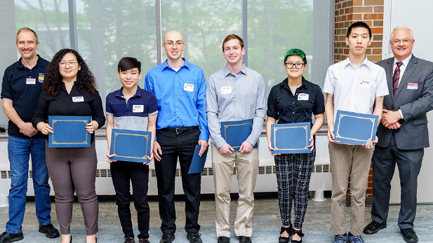 Rose-Hulman physics and optical engineering students holding awards.