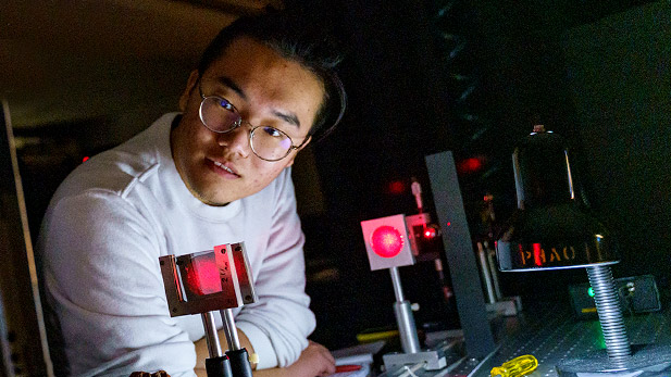 Zhaowei Chen works with optical engineering equipment at Rose-Hulman.