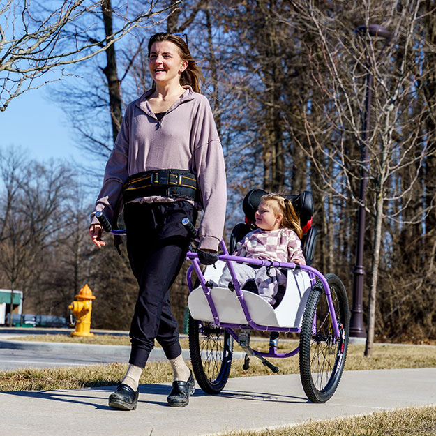 Briggs Fultz stands in the middle of Meela in her wagon alongside her family.