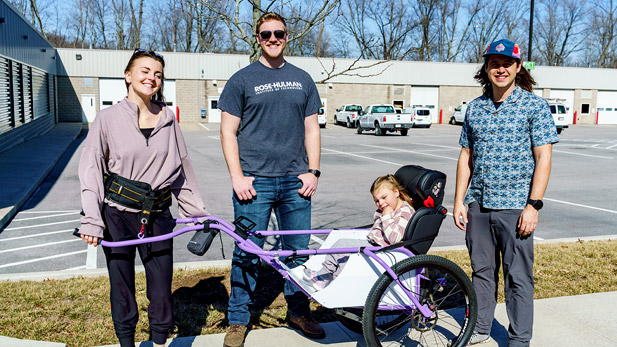 Briggs Fultz stands in the middle of Meela in her wagon alongside her family.