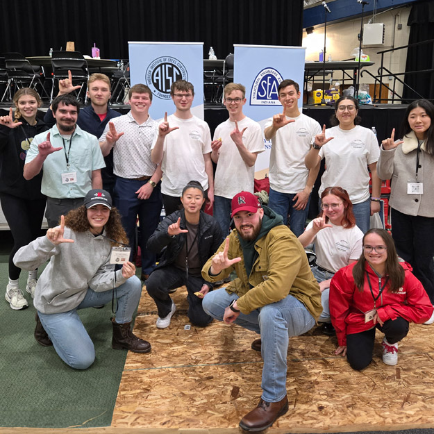 Photo of Rose-Hulman's steel bridge team on stage accepting their award, along with two smaller images of the team building its bridge.