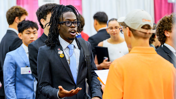 A student speaks with an employer at the Fall Career Fair.