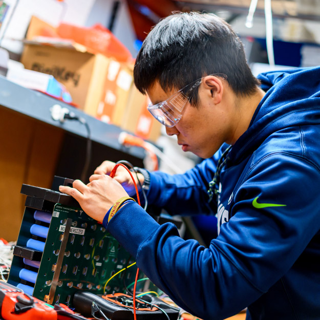 A GPE team member working on electronic components in the Branam Innovation Center.