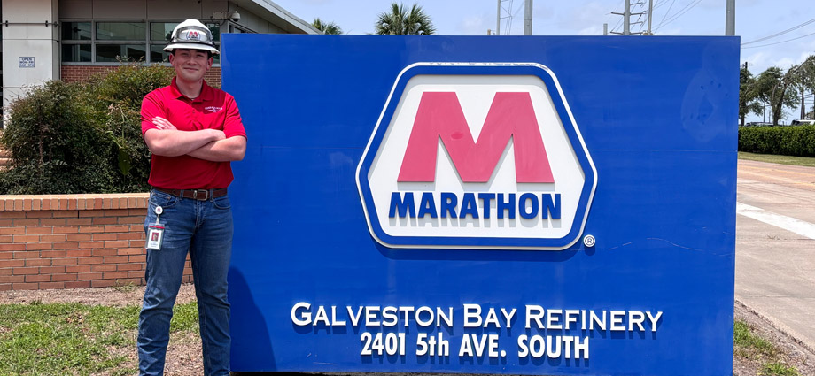 Griffin Lawrence stands in front of the Marathon Petroleum sign.